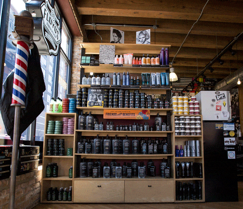 A wall of Floyd's 99 Barbershop professional hair products available at every shop.